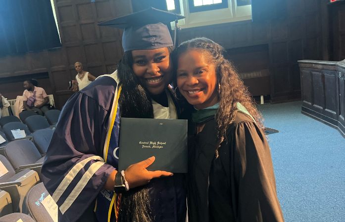  Graduate posing with teacher